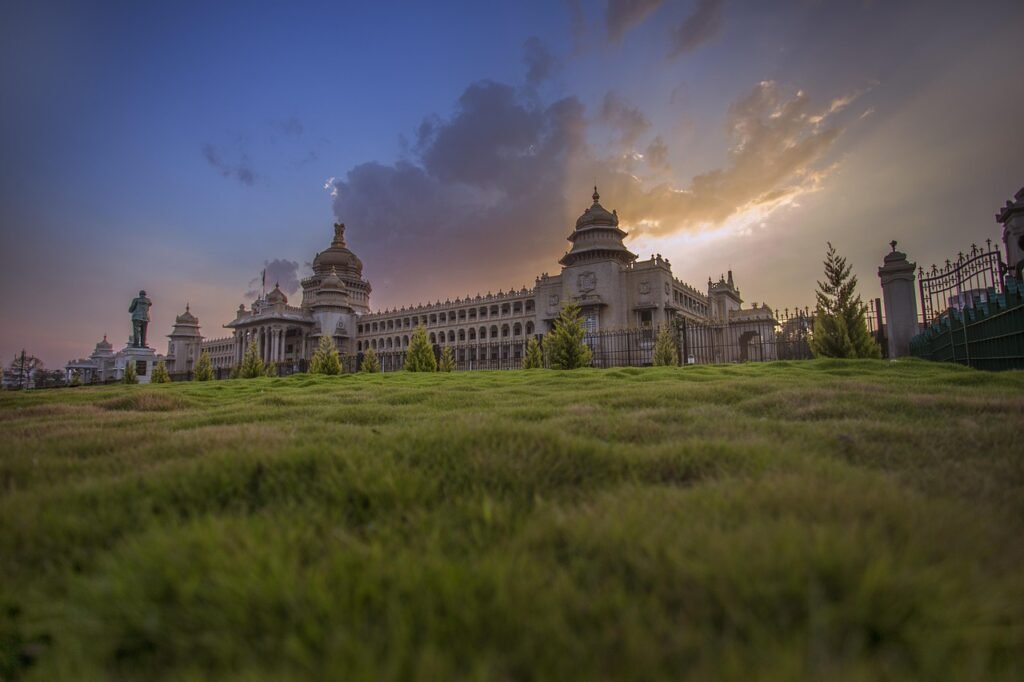 architecture, travel, outdoors, sky, ancient, vidhan, soudha, bangalore, bengaluru, palace, grass, green, sunset, building, india, indian architecture, legislature, karnataka, nature, tourism, landmark, landscape, history, traditional, historic, historical, park, vintage, stone