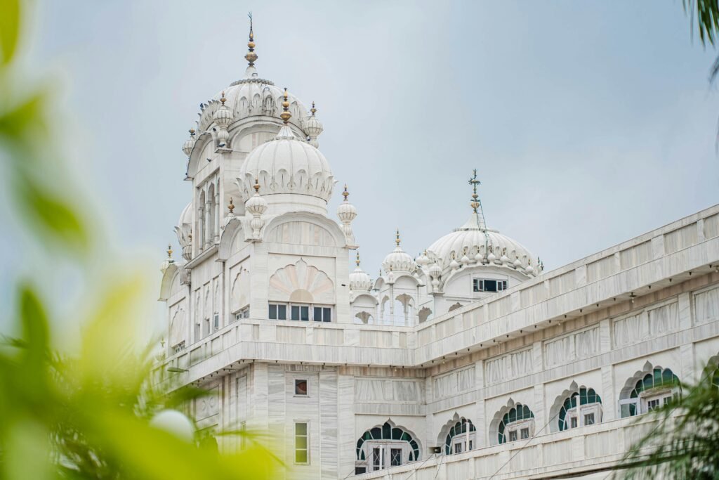 Elegant white temple with domes and intricate architecture in Ludhiana, India.